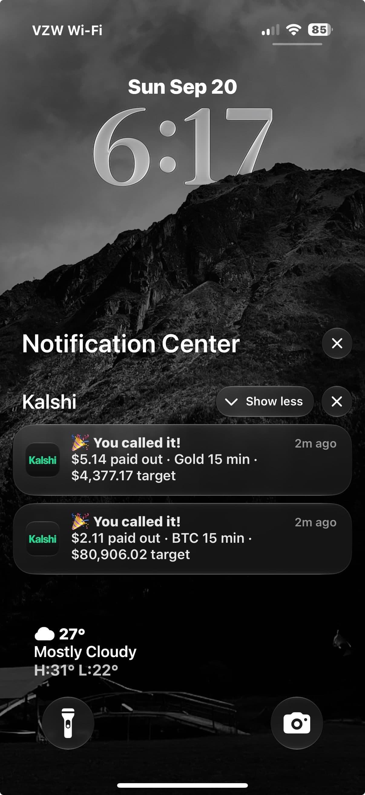 Phone lock screen with Kalshi payout notifications for Gold and BTC 15-minute trades on Sunday, September 20; year not shown.